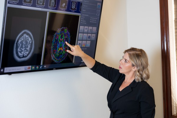 Photo of attorney Maxey Scherr looking at a brain scan